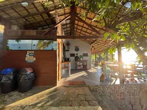 an outside view of a building with trash cans at Saracura in Praia de Araçatiba