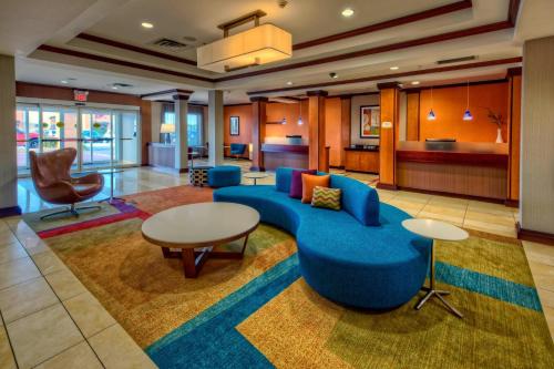 a lobby with a blue couch and a table at Fairfield Inn & Suites by Marriott Oklahoma City NW Expressway/Warr Acres in Oklahoma City