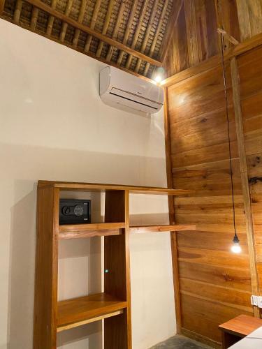 a room with wooden shelves and a ceiling at Sky Mountain Views in Kuta Lombok