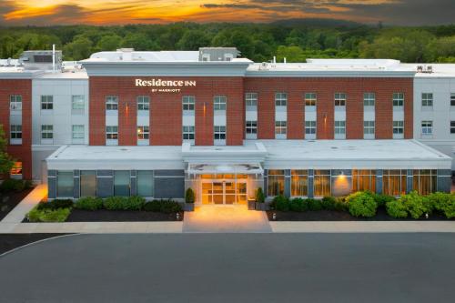 a large red brick building with a sign on it at Residence Inn by Marriott Boston Concord in Concord
