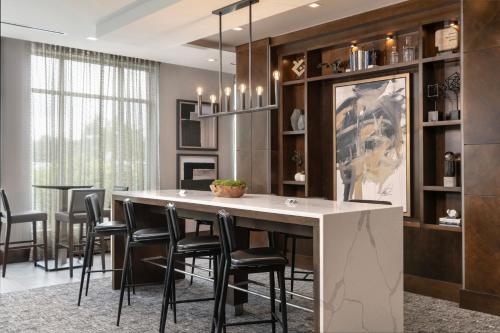 a dining room with a large table and black chairs at Residence Inn by Marriott Boston Concord in Concord