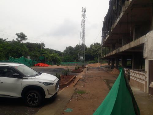 a white car parked in front of a building at Sri Kakateeya Grand Residency Bhadrachalam Hotel Residency Stay Rooms SRI SEETHA RAMA KAMMA VARI SEVA SAMITHI BHADRACHALAM in Bhadrāchalam
