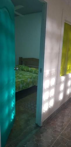a room with a bedroom with a bed and a door at Villa Marina in Moñitos