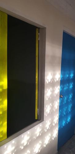 a mirror on the side of a wall with lights at Villa Marina in Moñitos