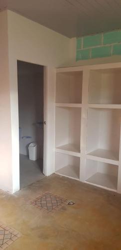 a room with white shelves in a room with a toilet at Villa Marina in Moñitos