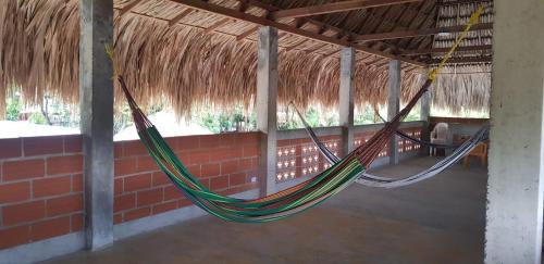 a room with two hammocks in a building at Villa Marina in Moñitos