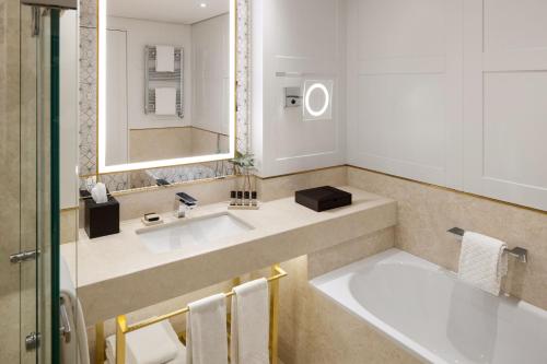 a bathroom with a sink and a mirror at The Alexander, a Luxury Collection Hotel, Yerevan in Yerevan
