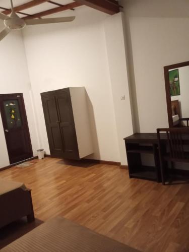 an empty room with a wooden floor and brown doors at Villa 95 Rangala in Kandy