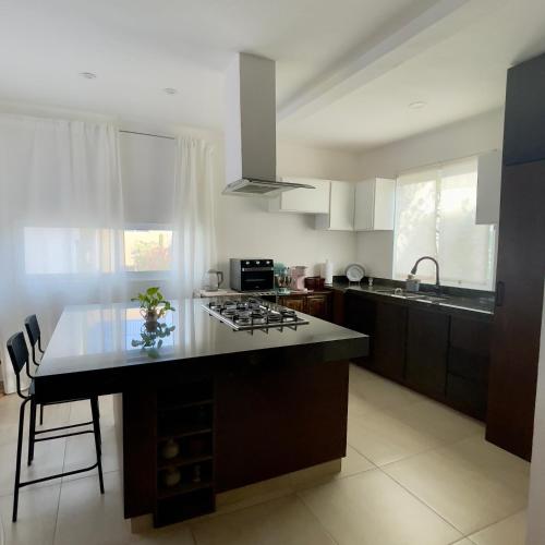 a kitchen with a island in the middle of it at Casa de Susie in Cabo San Lucas