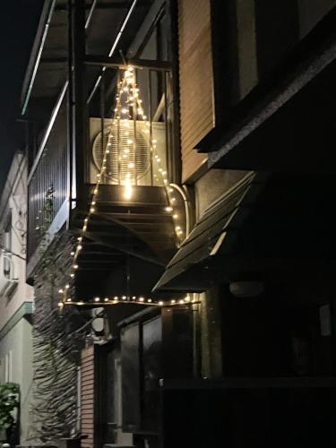 a chandelier hanging from the side of a building at night at アニメーションの起源地にある大泉学園ヴィラ in Katayama