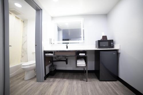 a bathroom with a sink and a toilet at Express Inn & Suites Ontario Airport in Ontario