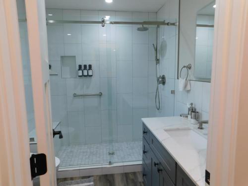 a white bathroom with a shower and a sink at Angies Oasis in San Ramon
