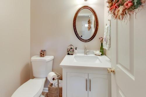 a bathroom with a sink and a toilet and a mirror at Cozy 3-bedroom townhome in Fairfax in Fairfax