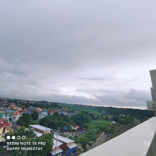 a view of a city from the roof of a building at Happy Homestay at Fullerton Suites Condo near Nuvali and Tagaytay in Silang