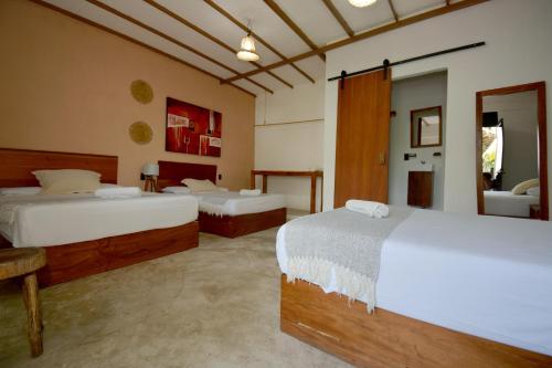 a hotel room with two beds in a room at Casa Delia Hotel Downtown in Bacalar