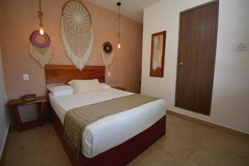 a bedroom with a large bed in a room at Casa Delia Hotel Downtown in Bacalar