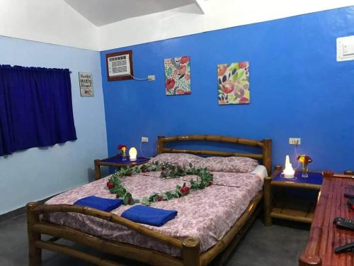 a bedroom with a bed with a flower arrangement on it at Sun House Rental in Mambajao