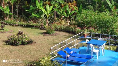 a group of blue chairs and a blue table at Sun House Rental in Mambajao