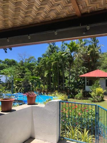 a view of a patio with plants and a fence at Sun House Rental in Mambajao