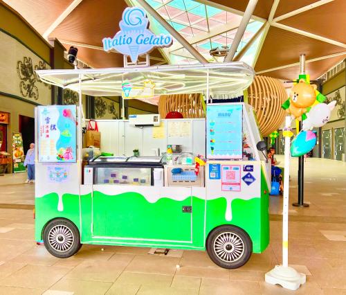 a green and white food cart in a mall at Legoland-3mins Drive KUROMI FAMIY SUITE in Iskandar Puteri