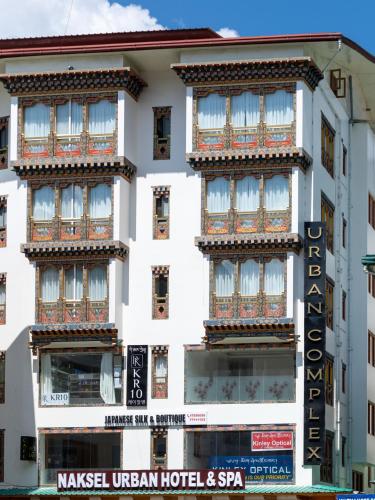 a white building with a sign in front of it at Naksel Urban Hotel & Spa in Thimphu