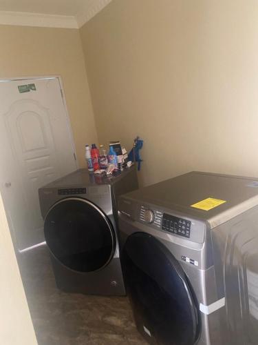 a room with a microwave and a bed and a computer monitor at De luna House in Cabrera
