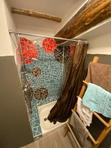 a bathroom with a shower curtain and a tub at nature Aubrac in Les Salces