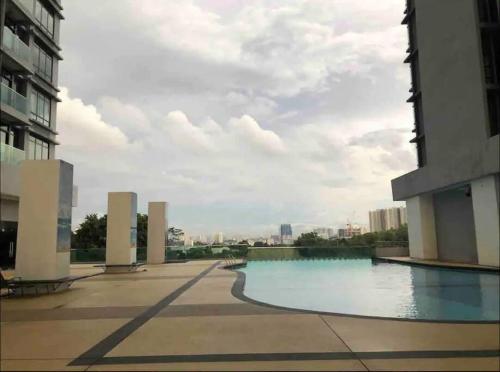 a pool of water in the middle of a building at City Of Green near Bukit Jalil Cozy 7pax 3R2B in Seri Kembangan