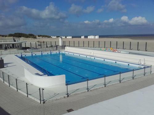 a large swimming pool on top of a building at Villa Parrain in Koksijde