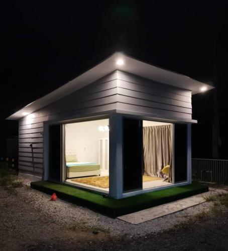 a small house with a window in the dark at Jeram Pantai Remis Studio in Jeram