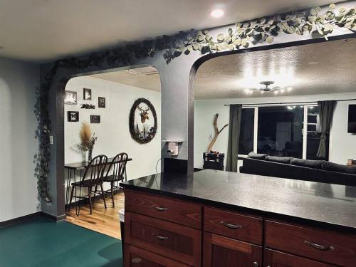 a kitchen with a large mirror and a dining room at Faerie Hollow in Eugene