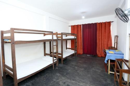 a room with three bunk beds and a window at Yarra BUNKZ Kandy in Kandy