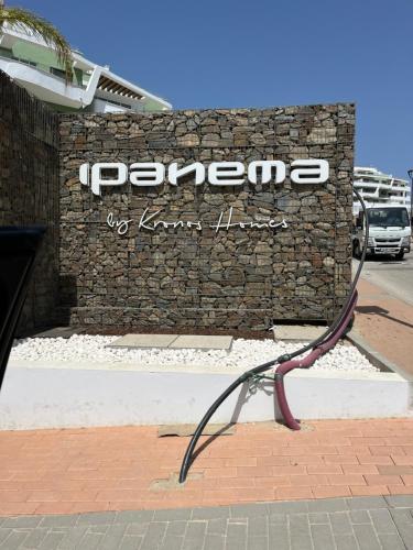 a bench on a sidewalk in front of a store at Ipanema la cala de mijas in Málaga