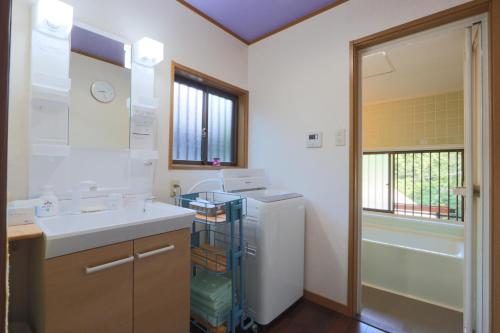 a kitchen with a sink and a refrigerator at なごみの里 in Shionoe