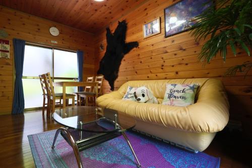 a living room with a couch and a table at なごみの里 in Shionoe