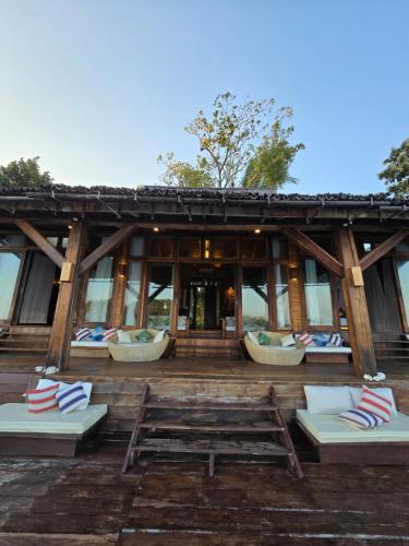 a building with lounge chairs in front of it at Full Moon Island Resort in Kaoh Sdach
