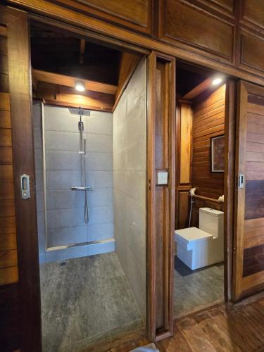 a bathroom with a shower and a toilet at Full Moon Island Resort in Kaoh Sdach