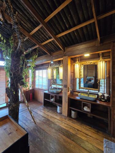 a bathroom with two sinks and a large mirror at Full Moon Island Resort in Kaoh Sdach