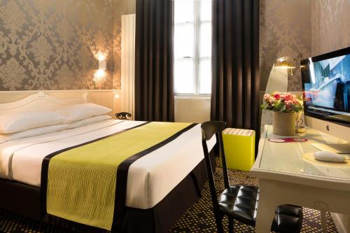 a hotel room with a bed and a desk at Hotel Design Sorbonne in Paris