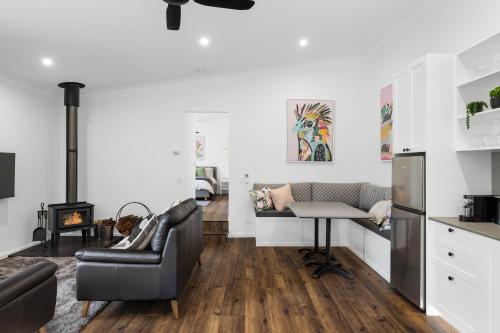 a living room with a couch and a table at Rainforest Luxurious Oasis 1BR Villa Free Wi-Fi in Springbrook