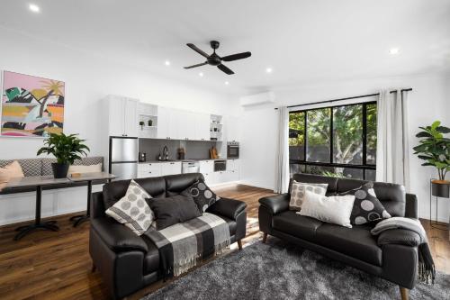 a living room with two leather chairs and a table at Rainforest Luxurious Oasis 1BR Villa Free Wi-Fi in Springbrook