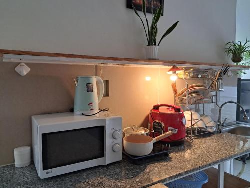 a kitchen counter top with a microwave and a mixer at MrLee Dalat House in Da Lat