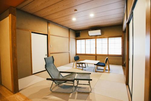 a room with chairs and a table in it at SATOYAMA STAY Tono-machi in Furukawachō