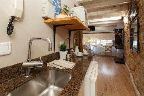 a kitchen with a sink and a counter top at AinB Picasso-Corders Apartments in Barcelona