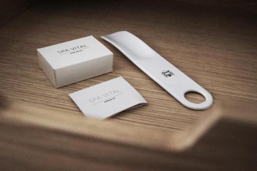 a wooden table with a box and a pair of scissors at Hotel Bella Italia in Sønderborg