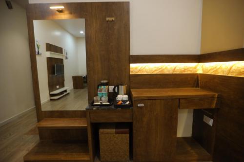 a hotel room with a sink and a mirror at THE GRAND ASTORIA SOMANTH by Shivalaya Darshanam in Somnath
