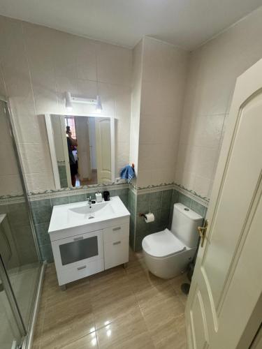 a bathroom with a toilet and a sink and a mirror at Brisa y Mar Aguadulce II in Aguadulce