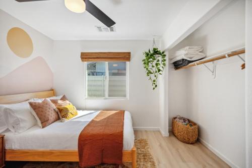 a bedroom with a bed and a window at Tangerine House - Hot Tub, Fire Pit, BBQ! home in Joshua Tree