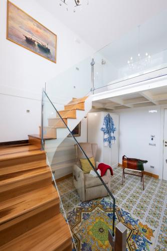a living room with a staircase and a couch at Residenza Luce in Amalfi
