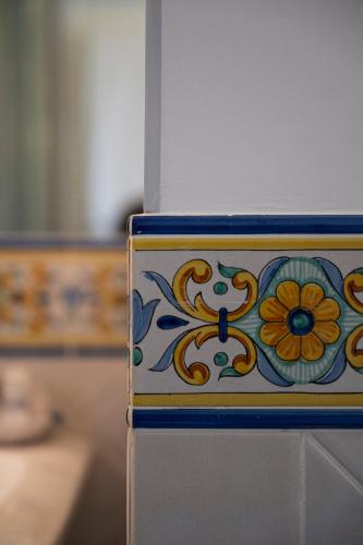 a box with a flower painted on it at Residenza Luce in Amalfi